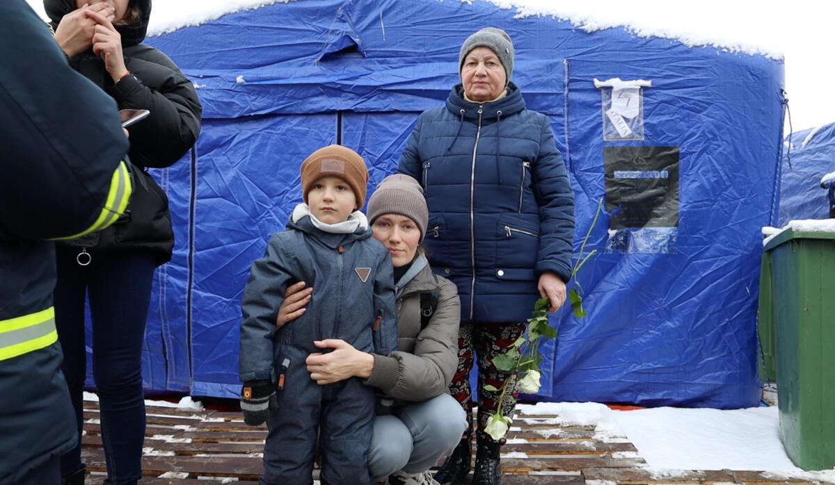 Julia, hugs her 3-year-old son, Nicom at a refugee camp in Romania after fleeing Ukraine.