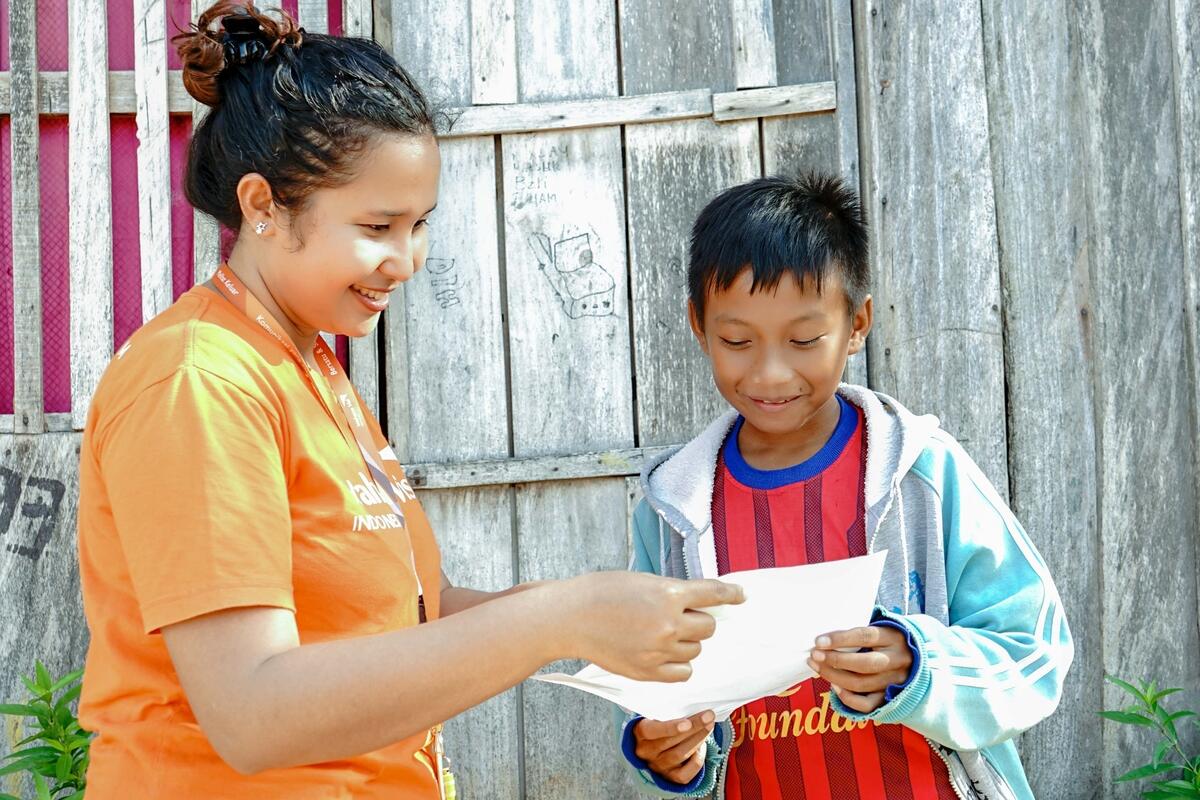 Jackly from Indonesia is happy to read a letter from his sponsor. He gets the letter from a staff.