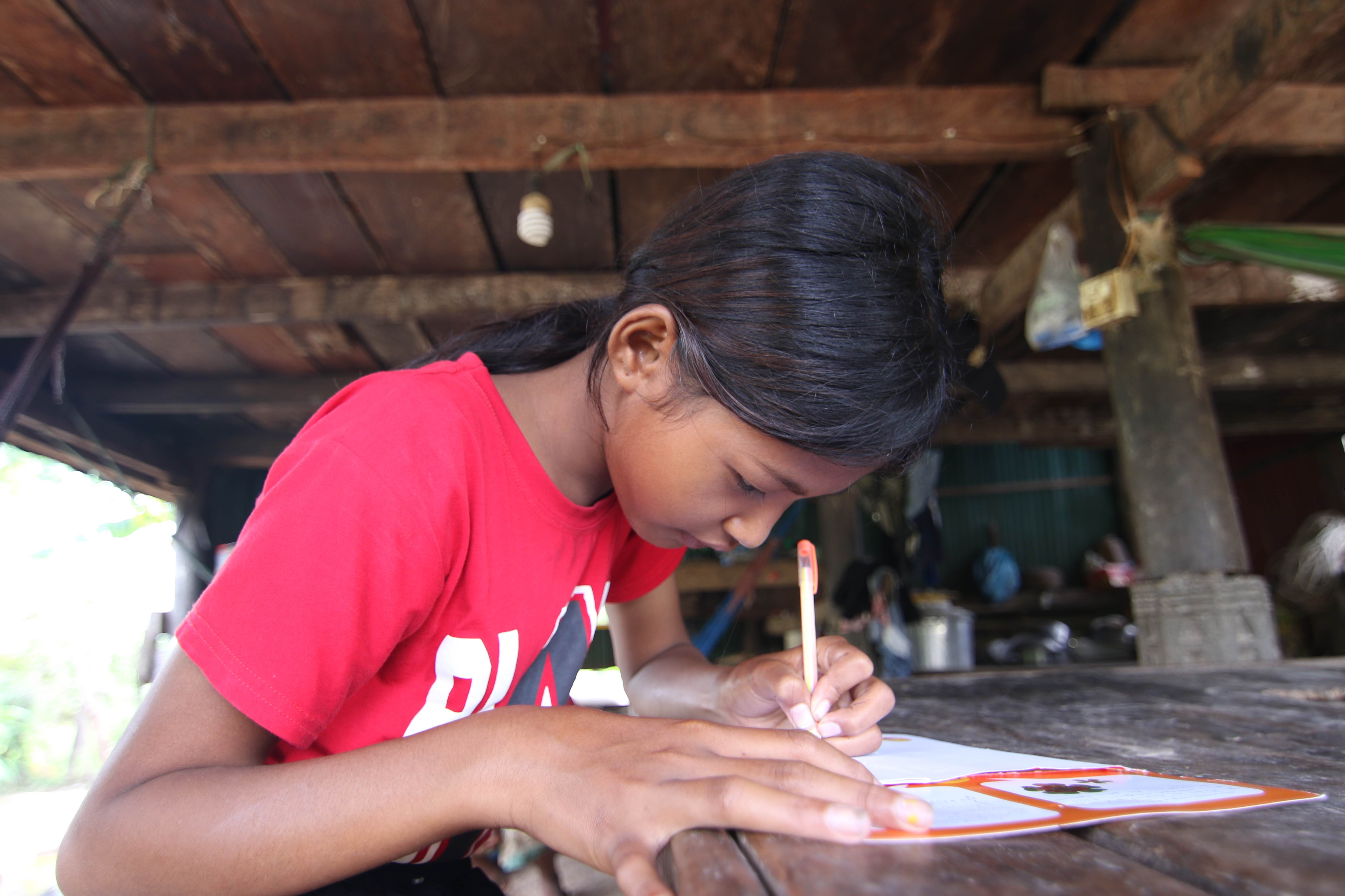 13 year old Ny from Cambodia writes cards for her sponsor
