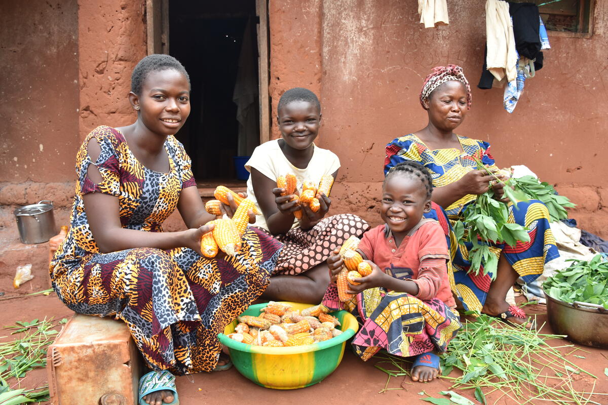 DRC_Louise, 16, Bienvenue 12, Alice, 8, and her mother Patience are pulping the cassava leaves