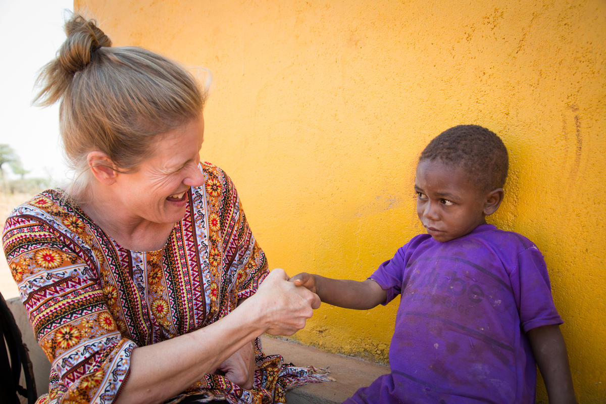 A World Vision ambassador pays visit to a sponsored child in Tanzania