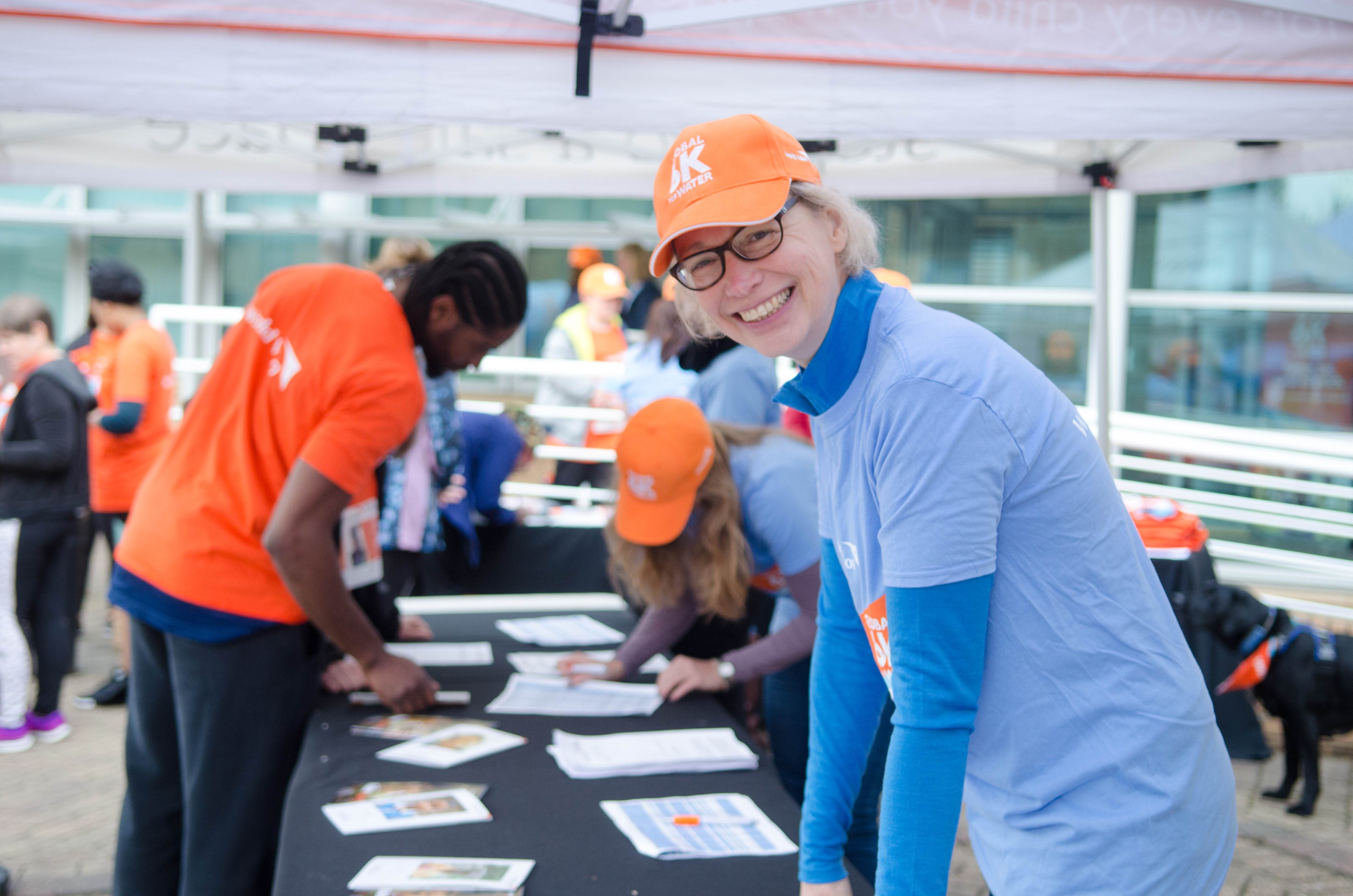 A volunteer gets involved at a World Vision event helping to register participants at an event