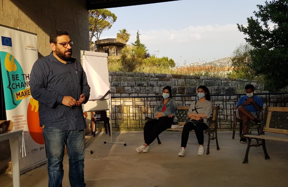 Chafic, a public relations co-rdinator for the Douris municipality in Lebanon presents to members of a local youth committee
