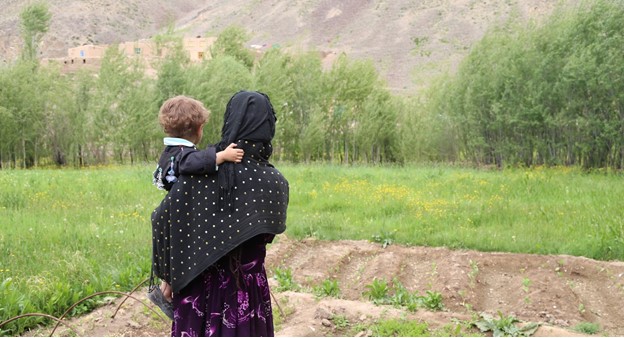 A woman carrying a child in Afghanistan