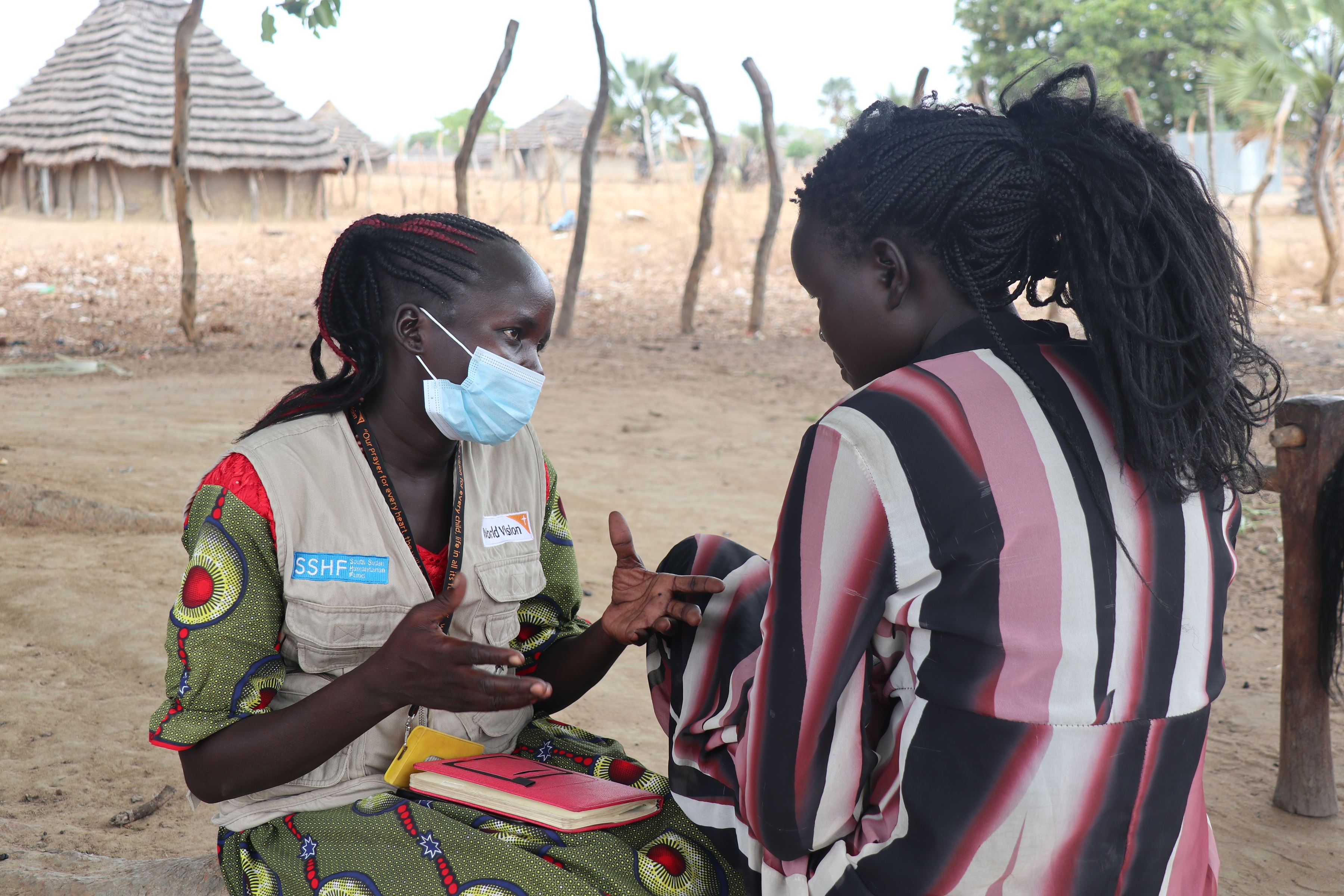 World Vision’s Social Worker Pasquina Diu interacts with South Sudanese girl Katina in one of her visits.