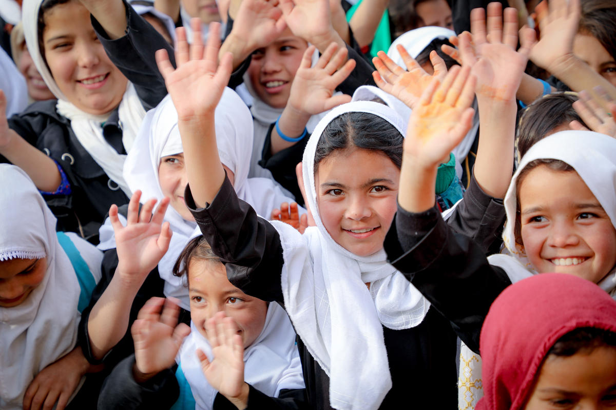Children in Afghanistan raise hands