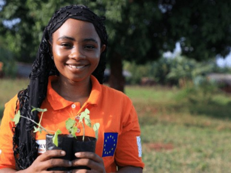 Girl holding plant