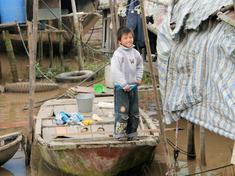 Boy standing on boat