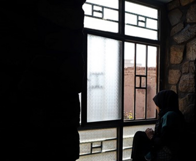 afghanistan woman sitting by the window
