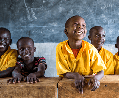 School children smiling in a class room 