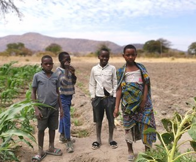 Four kids standing in a field