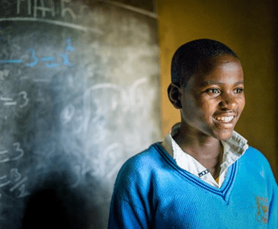 A Boy inside a class room.