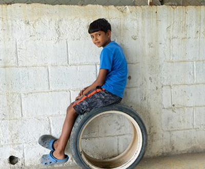 Boy sitting on a wheel