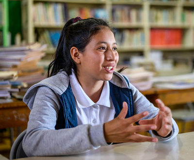Nahomy sits in her book-lined classroom, and talks about the difference sponsorship has made to her life