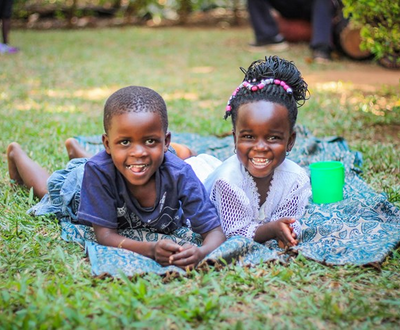 Boy and girl from Uganda lying in the ground