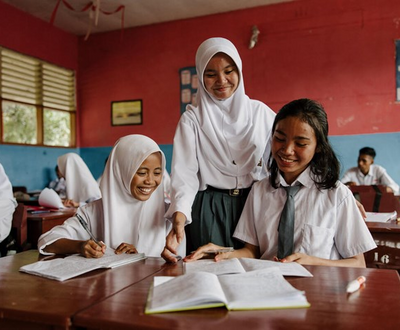 Girls sitting in their classroom reading a book