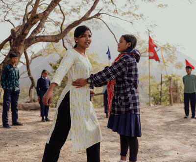 Susma teaching the young girls self defense outside
