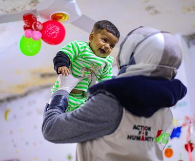 One of the Action for Humanity staff playing happily with Selma