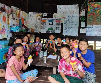Naw Htwe, 12 years old, smiles during a reading club session in Lat Pan kone Village