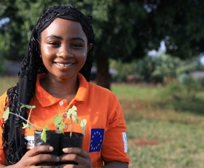Amina Athuman with seedling trees to plant at her home in Ugweno village, Tanga region.