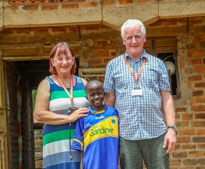 Sarah and John Osborne in Uganda with their sponsored child, Yazidi