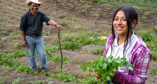 Nahomy helping her father in the field