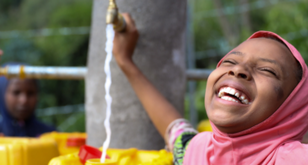sitina smiling and playing with water