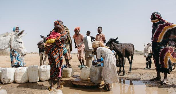 Residents collect water at a World Vision-built water point in Shearyia El Nakheel camp, North Darfur