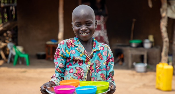 Child holding plate of food