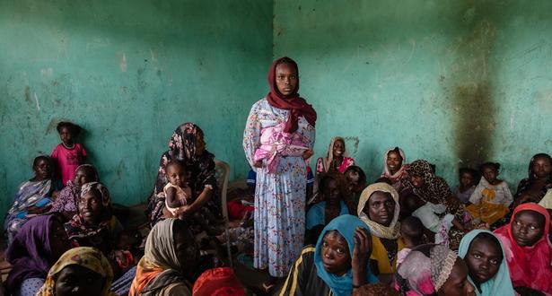 People queue to receive ready-to-use therapeutic food (RUTF) at El Ferduouse clinic, South Darfur.