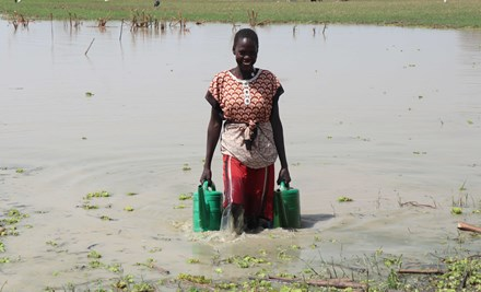 Ator collects buckets of water to irrigate her village's farm