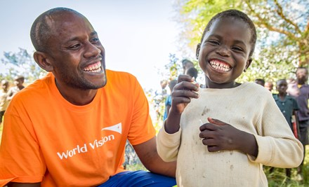 A boy with world vision staff