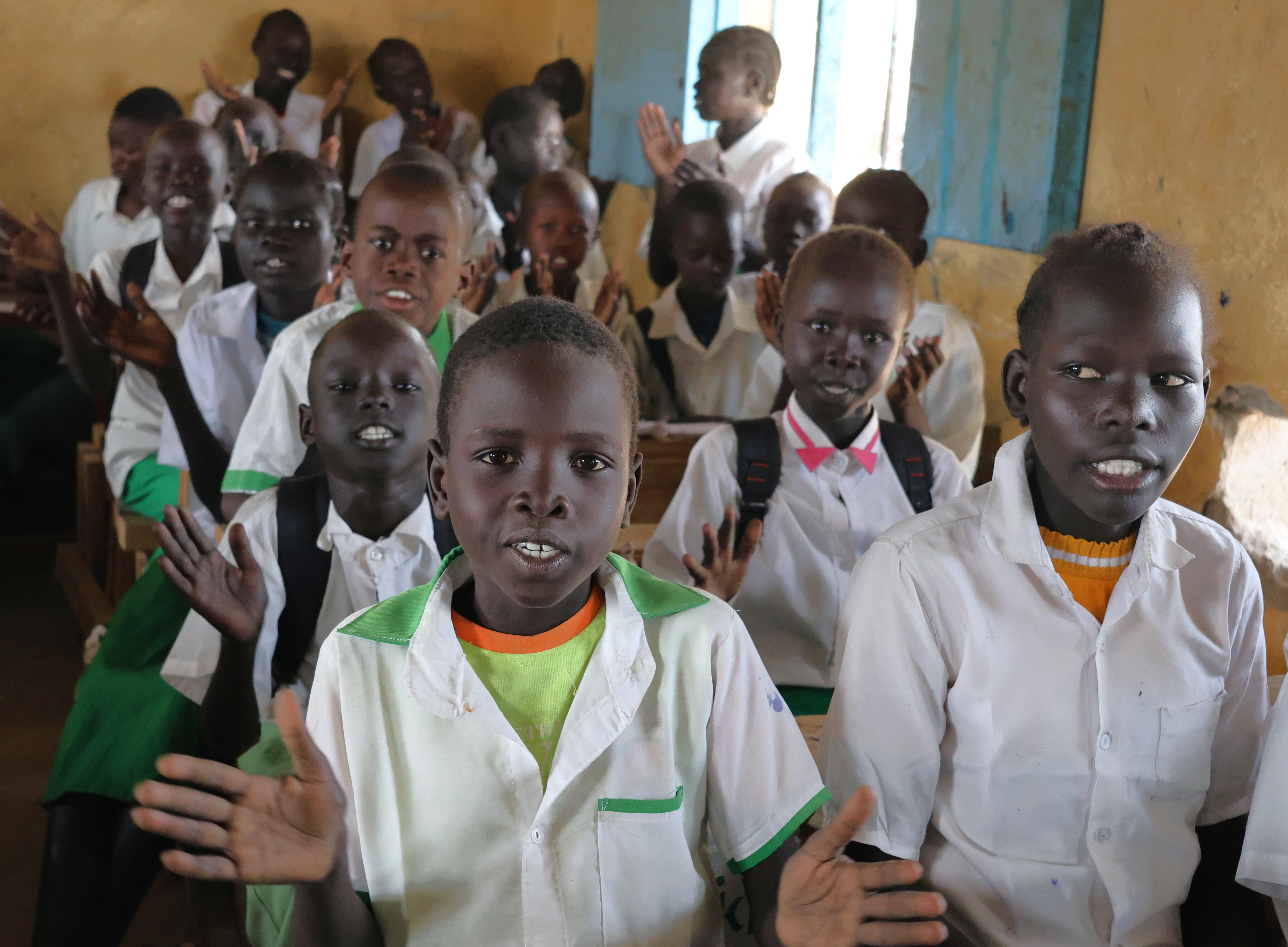 Pupils at Melut Primary School enjoying their newly received classroom desks 