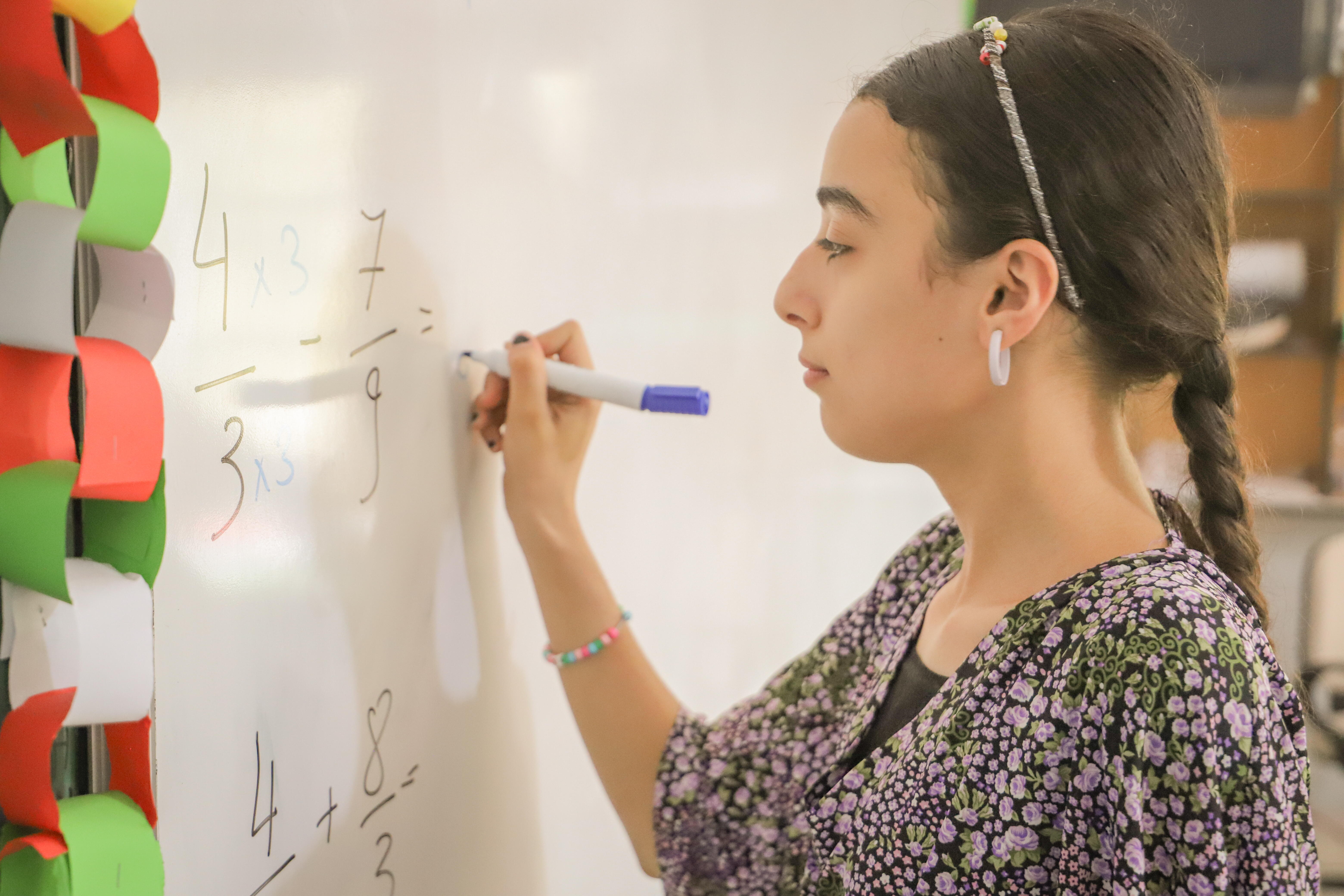 Asmaa writing on whiteboard