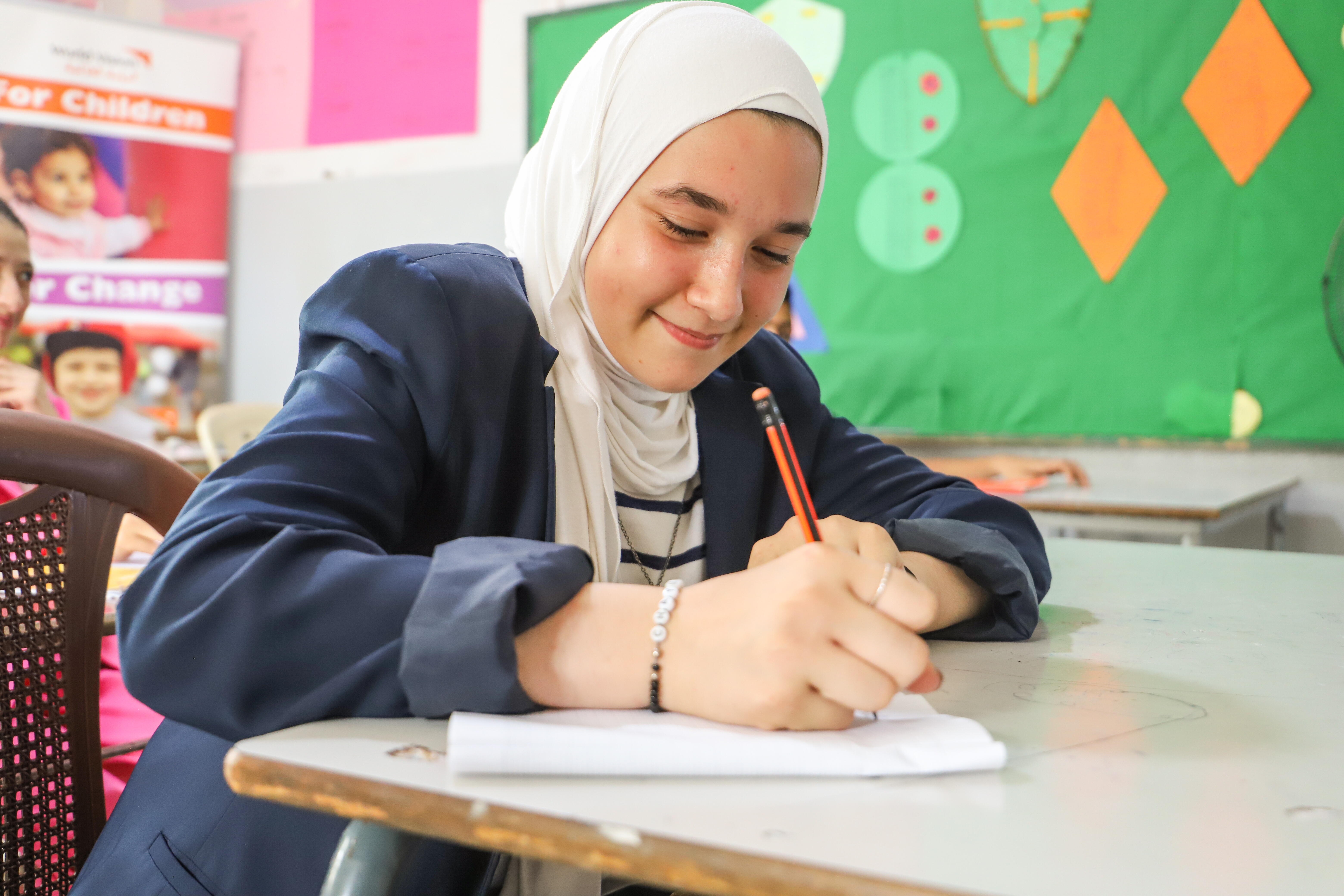 Shaymaa writing in class