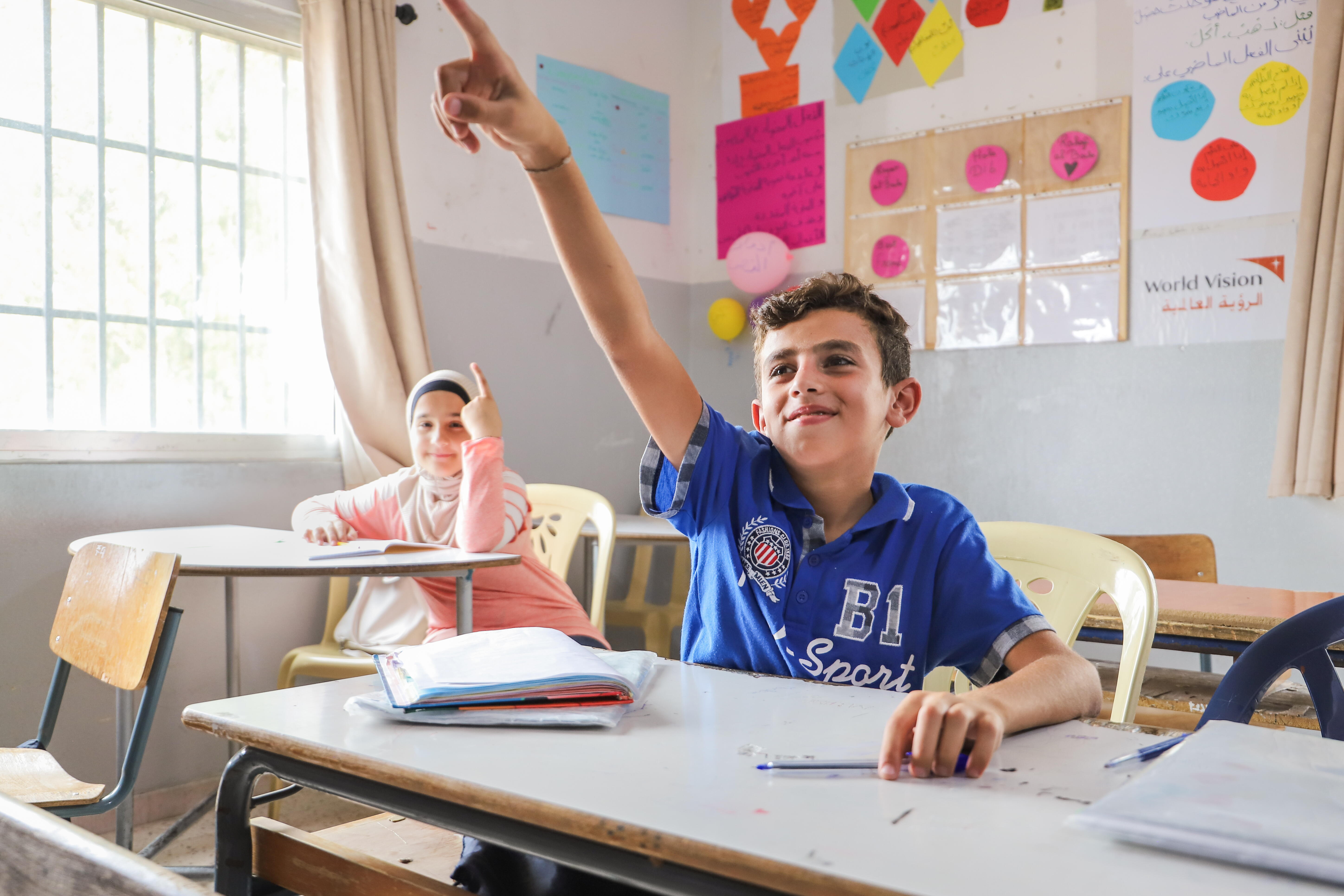 shabaan with his arm raised in class