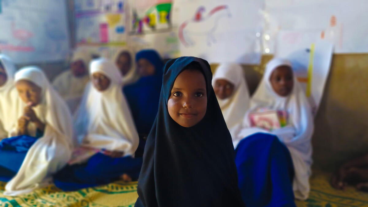 A 4 year old girl at the reading club in a local primary school in Puntland, funded by Irish Aid.