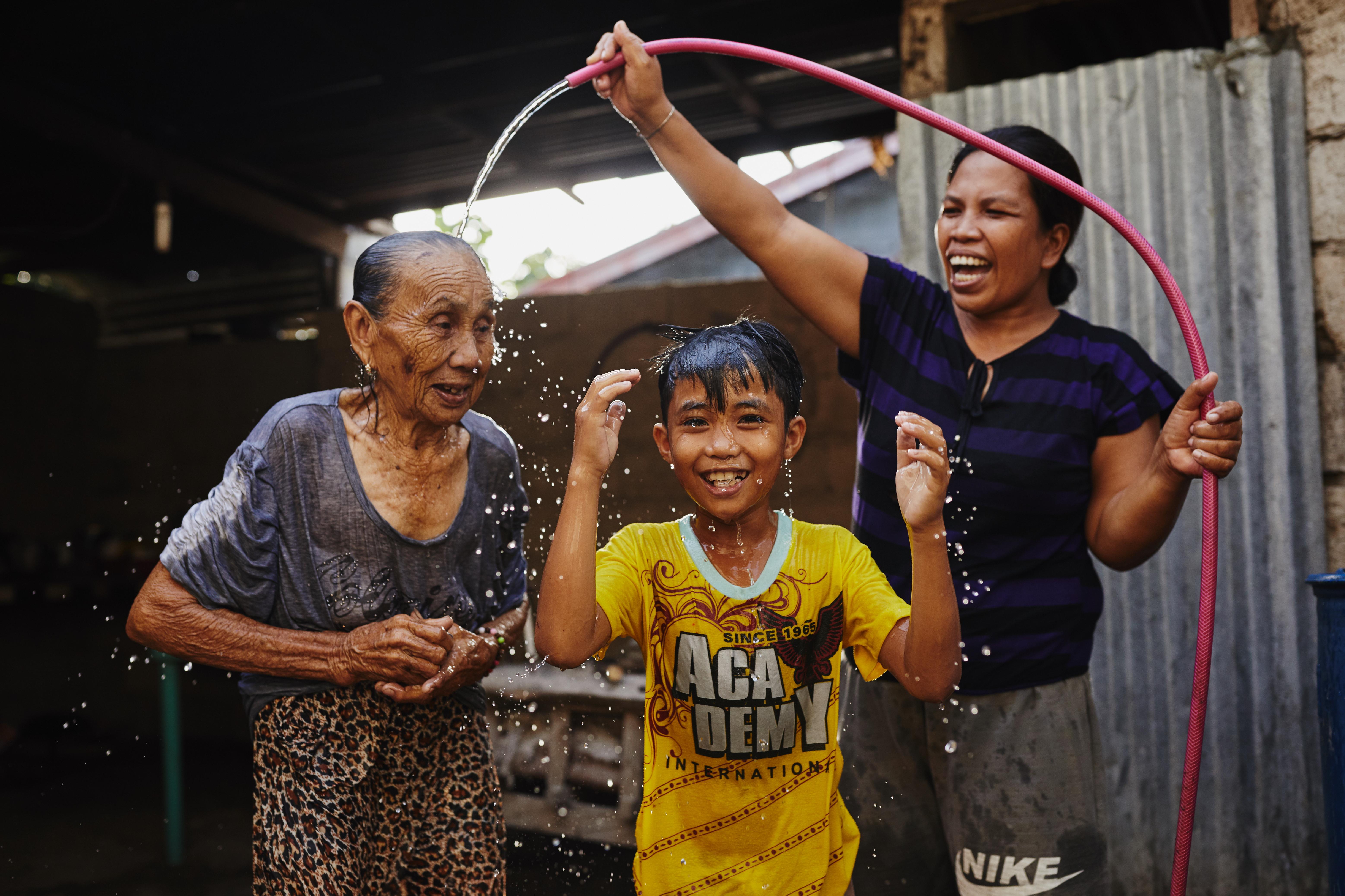 Child and family with water hose
