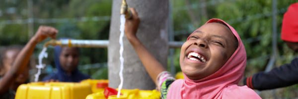 sitina smiling and playing with water