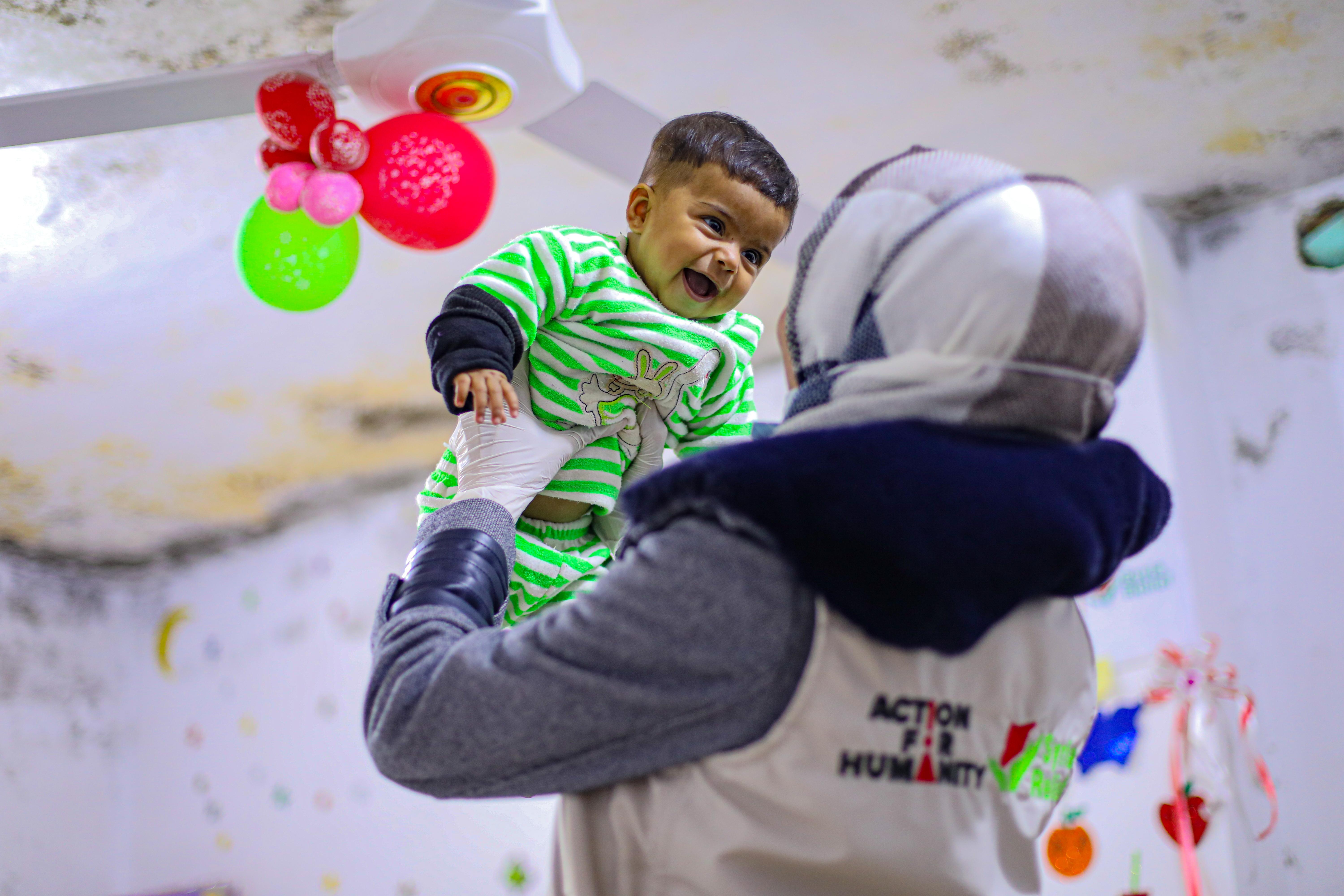 One of the Action for Humanity staff playing happily with Selma