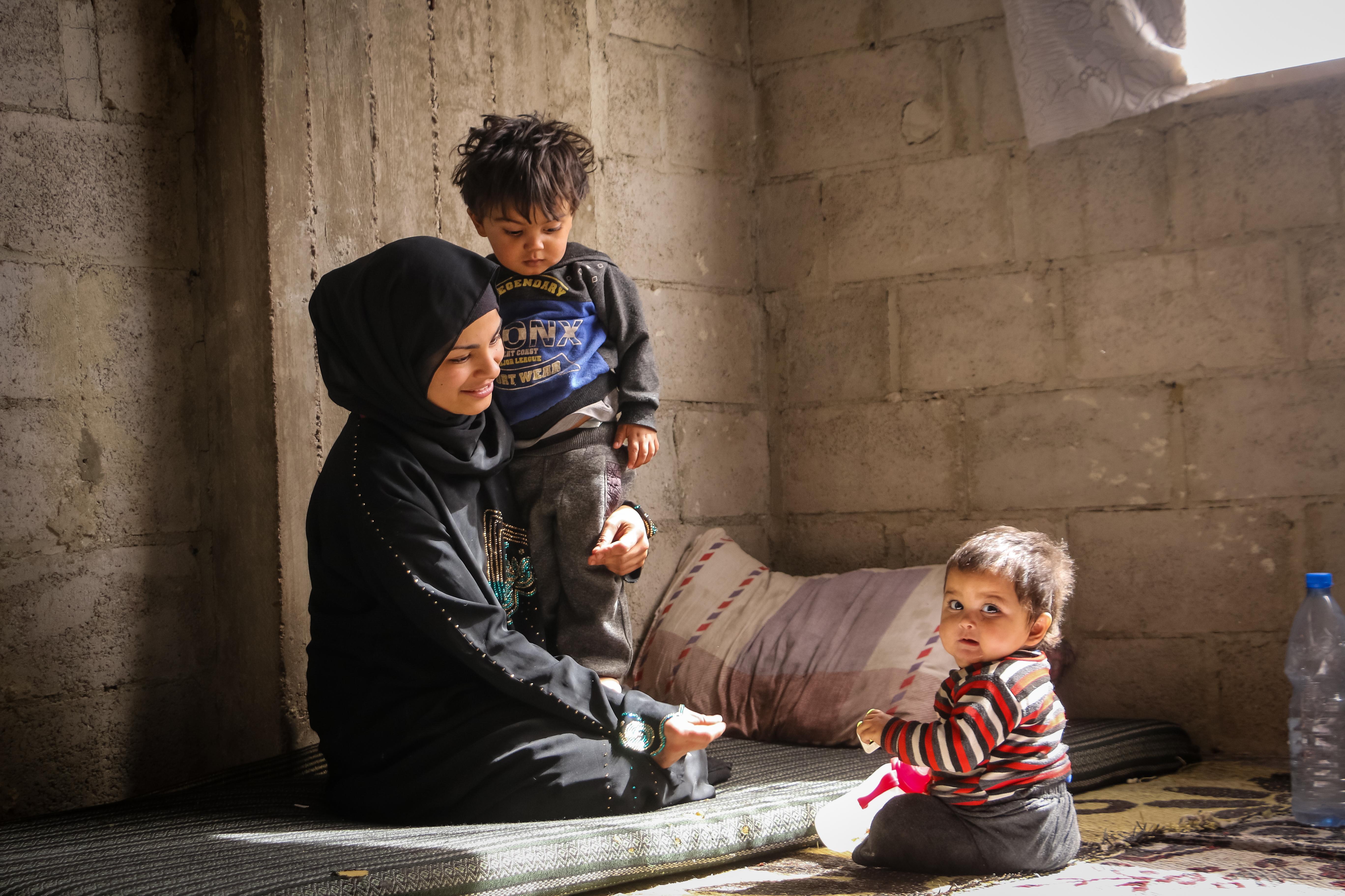 Shaima* and her children after receiving the nutrition kits.