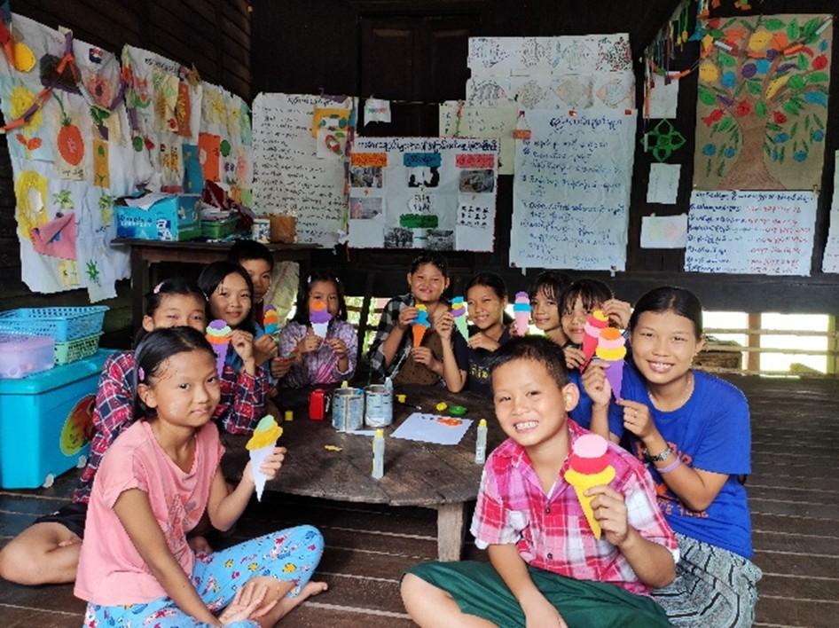 Naw Htwe, 12 years old, smiles during a reading club session in Lat Pan kone Village