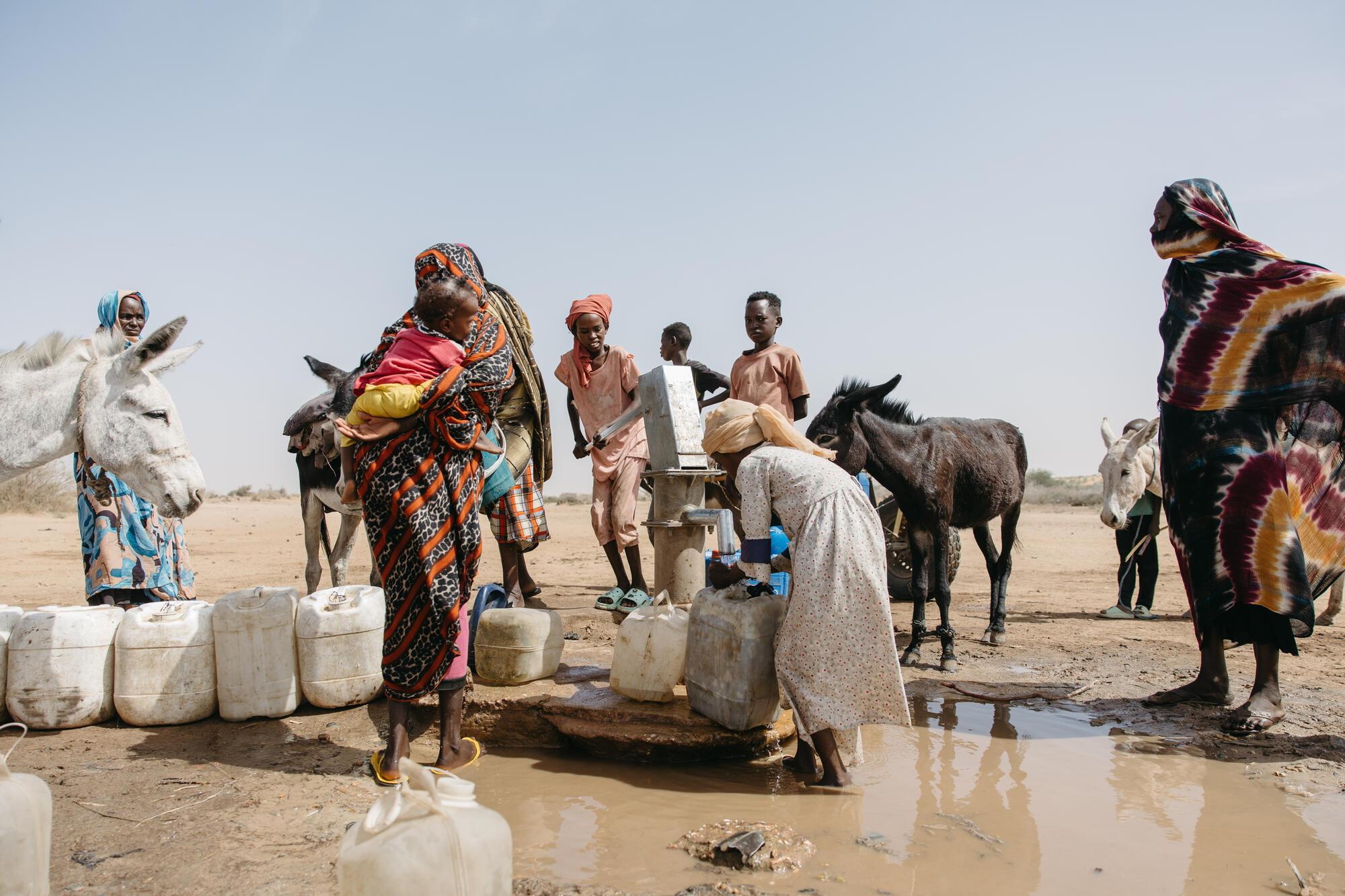 Residents collect water at a World Vision-built water point in Shearyia El Nakheel camp, North Darfur