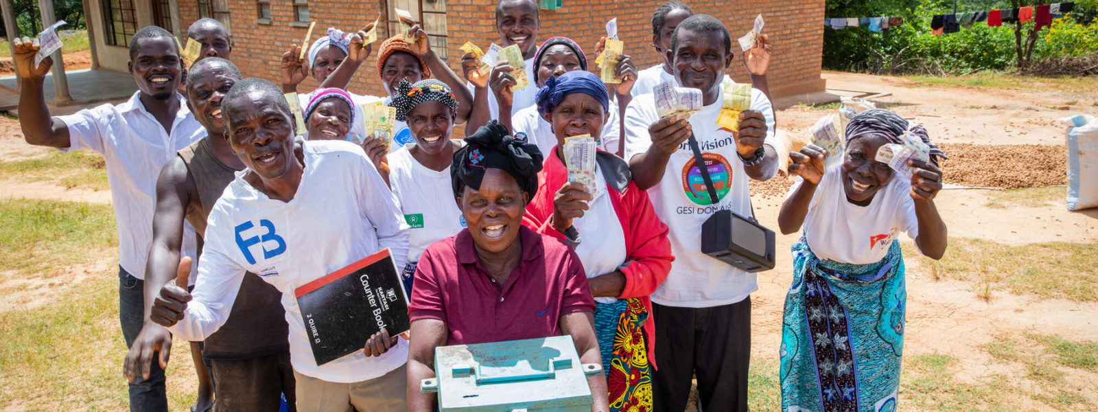 Members of the Satemwa Savings for Transformation group together with the box where they keep their savings