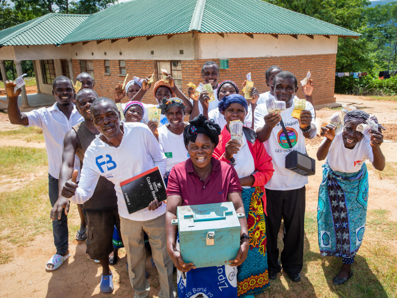 Members of the Satemwa Savings for Transformation group together with the box where they keep their savings mobile header