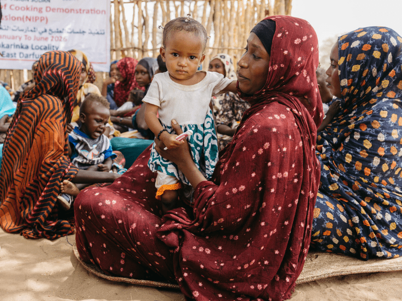 Sudanese mother holding her child mobile