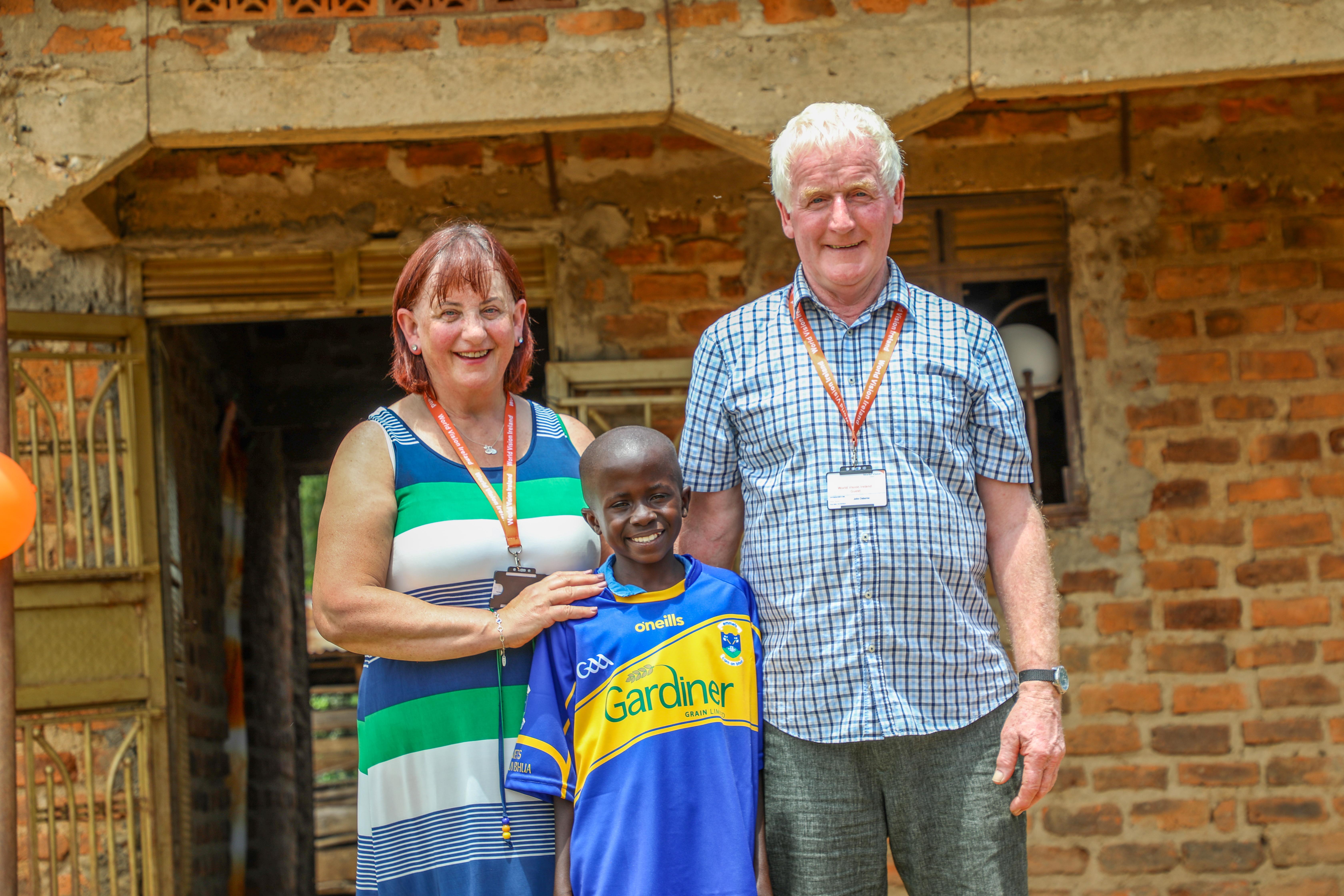 Sarah and John Osborne in Uganda with their sponsored child, Yazidi