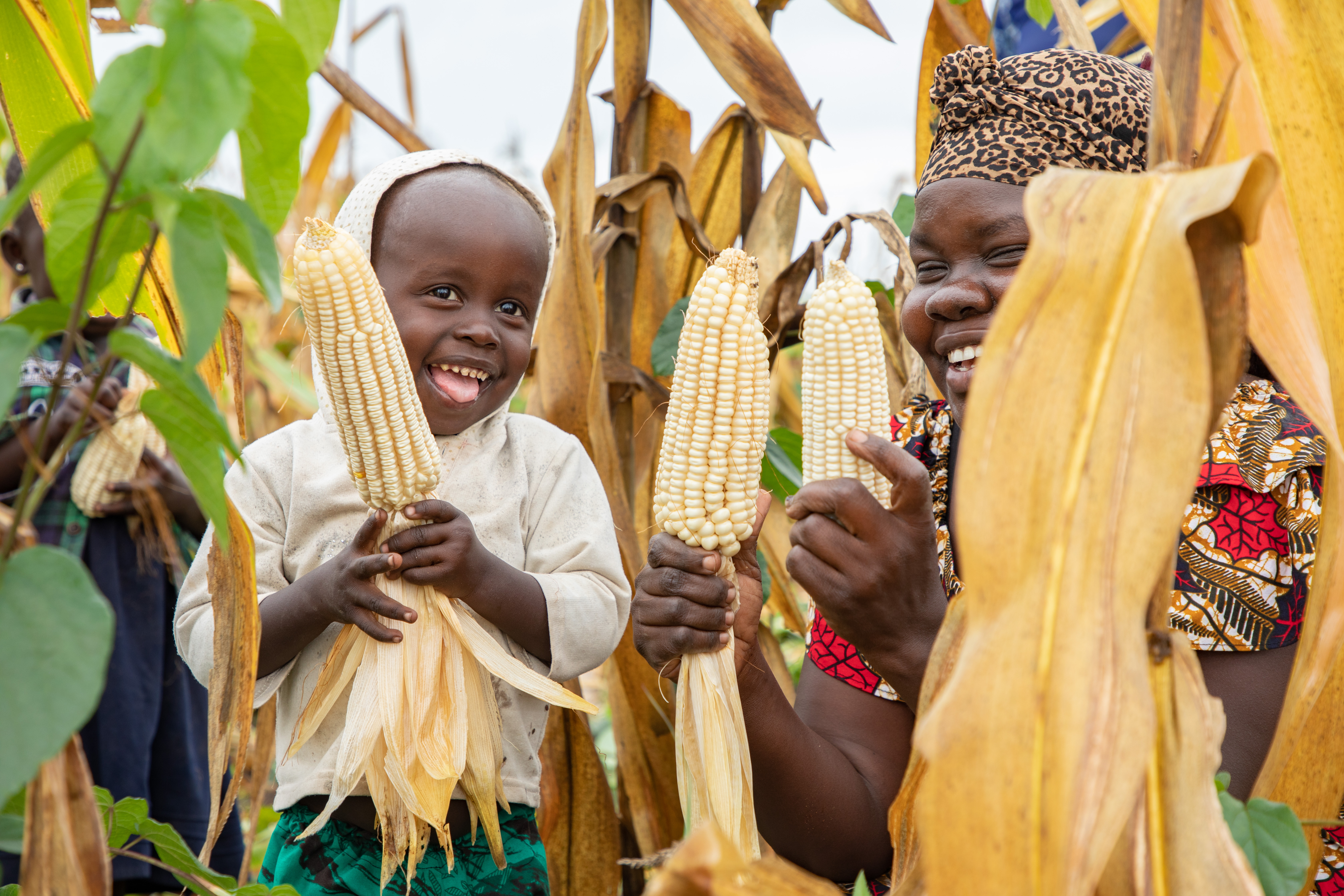 Mother and child holding corn