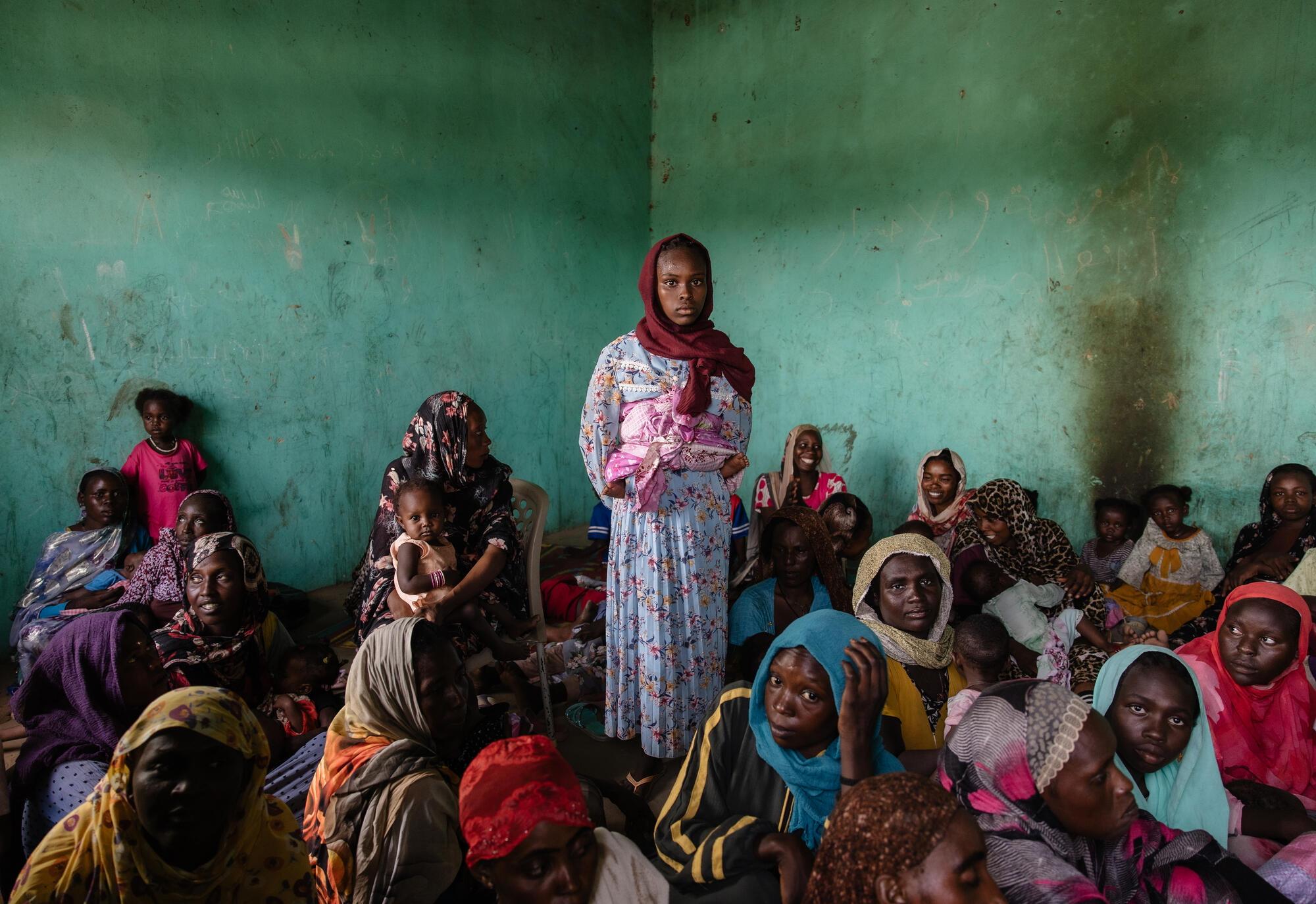 People queue to receive ready-to-use therapeutic food (RUTF) at El Ferduouse clinic, South Darfur.