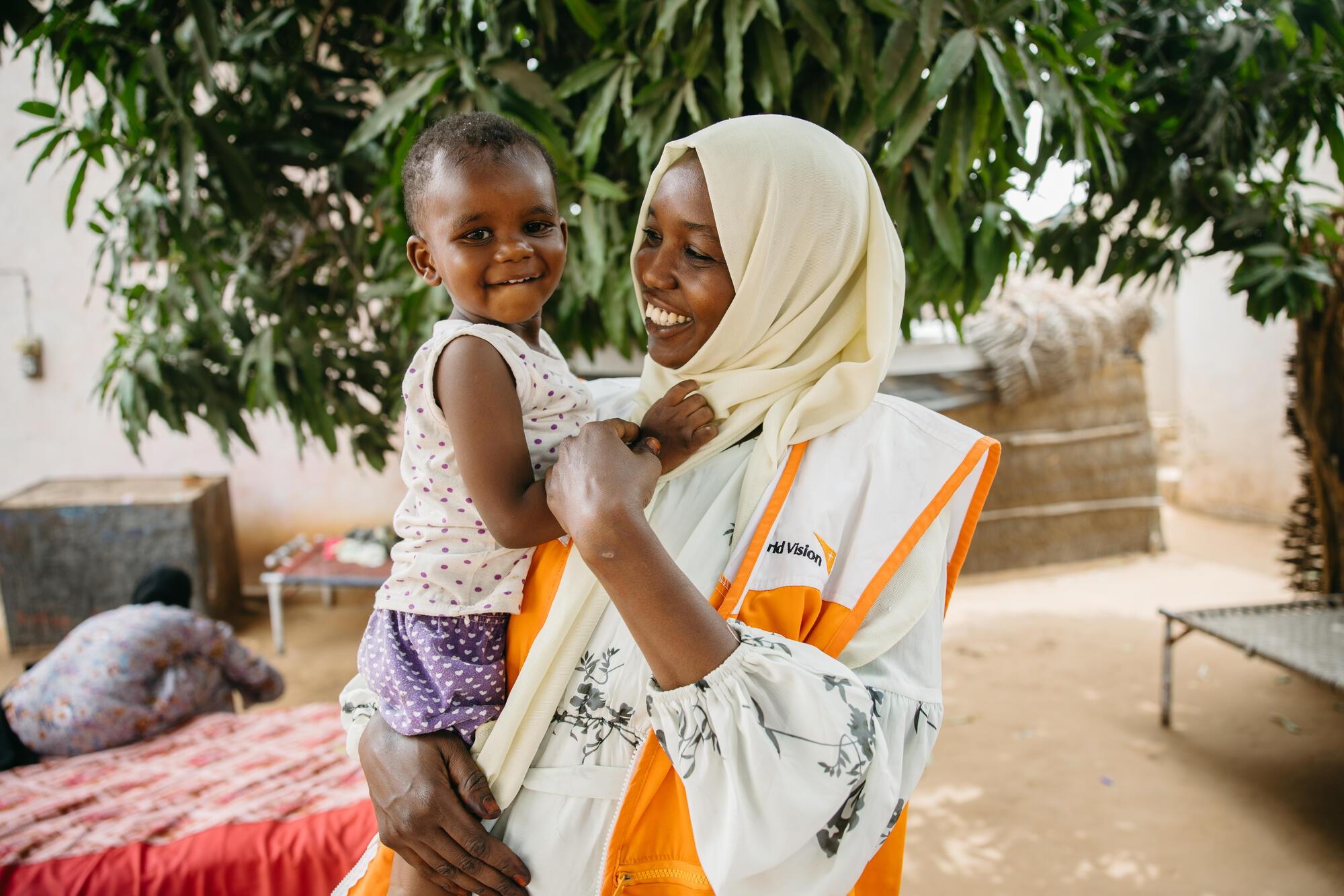 Fatima Ibrahim Mohammed, World Vision Protection Officer, at home in El Dain, Eastern Darfur, with her son.